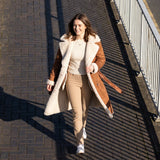 Tan belted shearling coat with cream wool trim