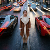 Tan belted shearling coat with cream wool trim